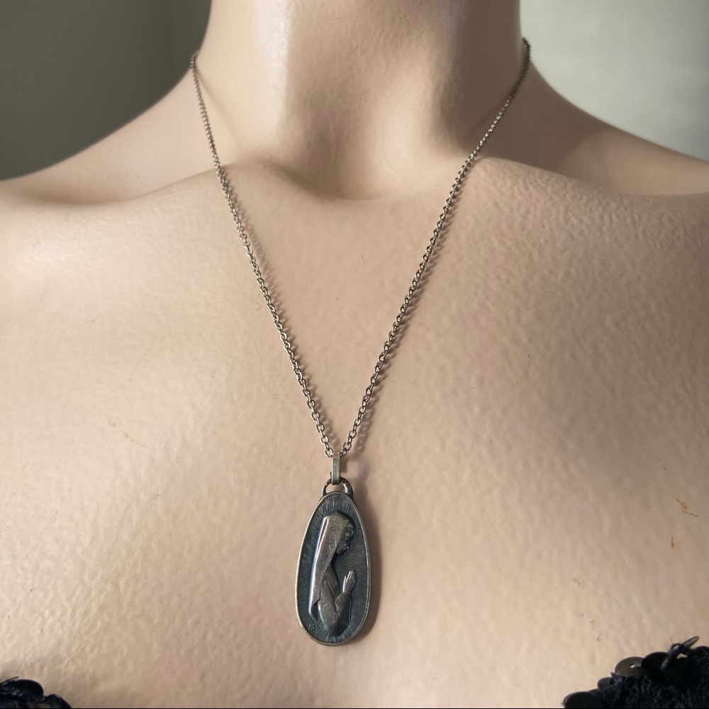 Our Lady of Fatima tear drop shape engraved silver tone women necklace. Used.